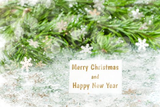 Fir tree branch and snow flares confetti with Merry christmas and Happy New Year text lettering. Merry christmas and New Year concept