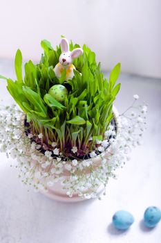 Easter eggs and bunny with flowers on a table