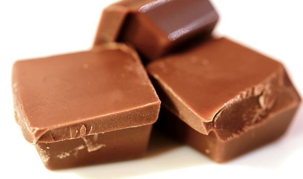 Macro shot of chocolate pieces on white background.