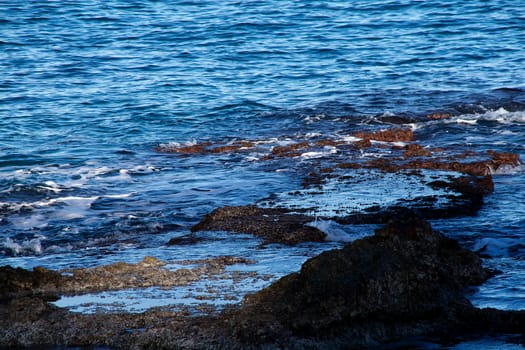 View of rocks, sea and waves in a small bay in Spain