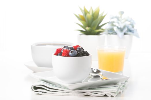Small bowl of fresh berries served with coffee and juice.
