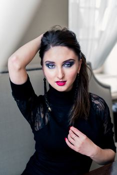 Portrait of a beautiful girl in black with makeup