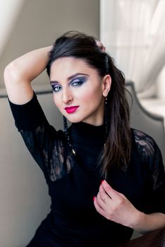 Portrait of a beautiful girl in black with makeup
