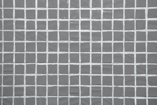 Texture of fine little ceramic tiles background. Grey floor tiles