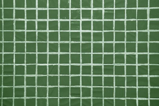 Texture of fine little ceramic tiles background. Green floor tiles