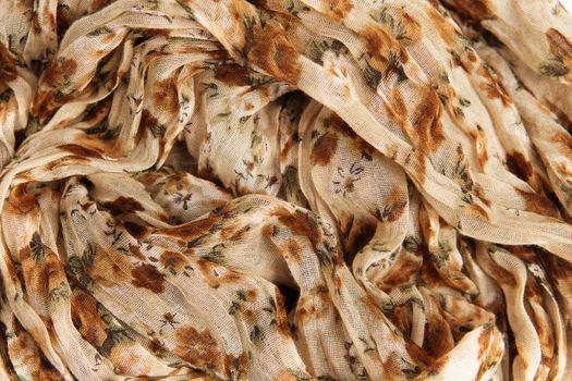 Flower patterned crumpled fabric texture background. Foulard made from modal and cashmere with a positional floral print