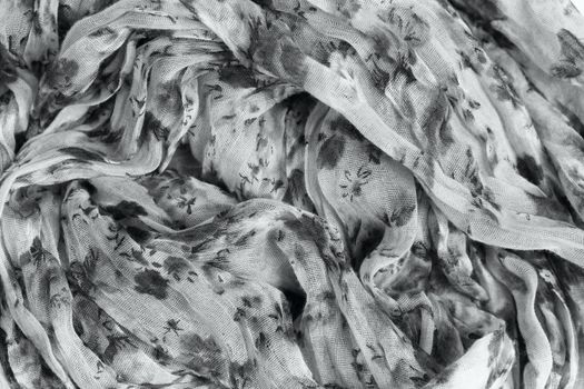 Flower patterned crumpled fabric texture background. Foulard made from modal and cashmere with a positional floral print