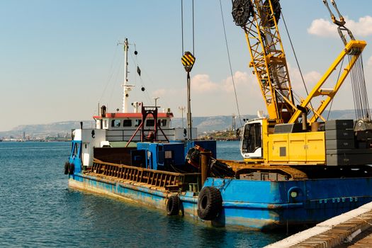 tug ship with cranes docked at the port