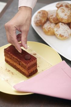 Woman confectioner preparing chocolate cake