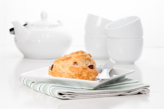 Fresh cranberry lemon scone served with coffee.