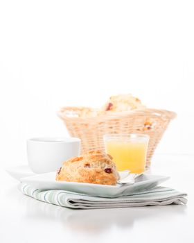 Fresh cranberry lemon scones served with coffee and juice.