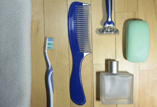 men's toiletries on wooden floor close to