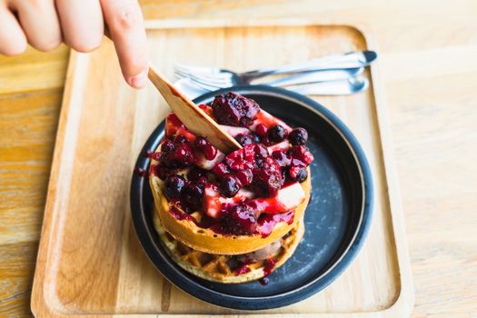 waffles and chocolate icecream with fresh berries on wooden tray