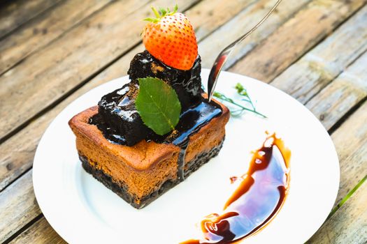 chocolate cake on white dish with strawberry