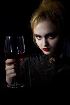 Young girl vampire on a black background