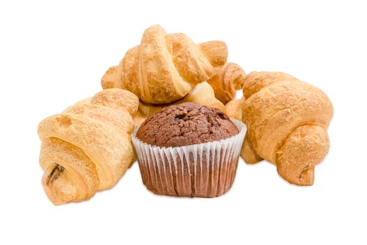 Several small croissant and sweet chocolate muffin in a paper cup on a light background
