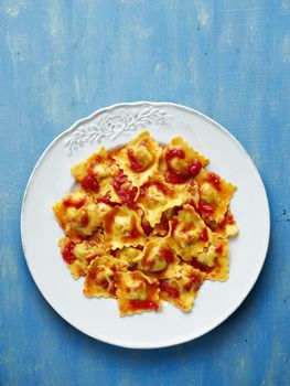 close up of a plate of italian ravioli pasta in tomato sauce