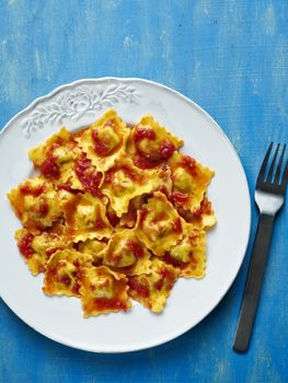 close up of a plate of italian ravioli pasta in tomato sauce