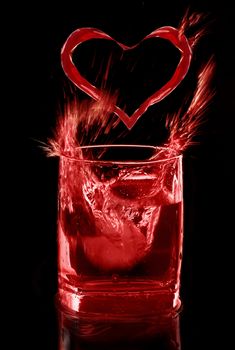 Red drink of love on black background, splash and heart