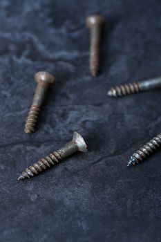 Group of rusty screws. Close-up vertical photo
