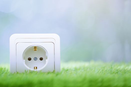 Electric outlet in the grass. Close-up photo