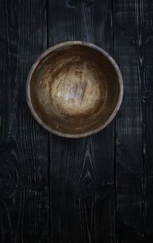 Empty wooden bowl on a vintage table