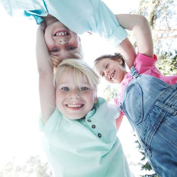 Group of smiling children looking down into camera