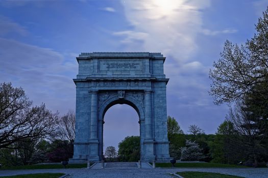 Springtime predawn moonlight at Valley Forge National Historical Park in Pennsylvania, USA.The National Memorial Arch is a monument dedicated to George Washington and the United States Continental Army.