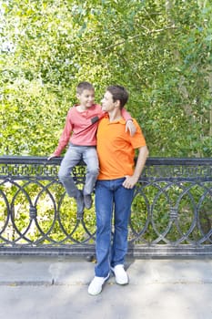 Father and son are looking each others in summer park