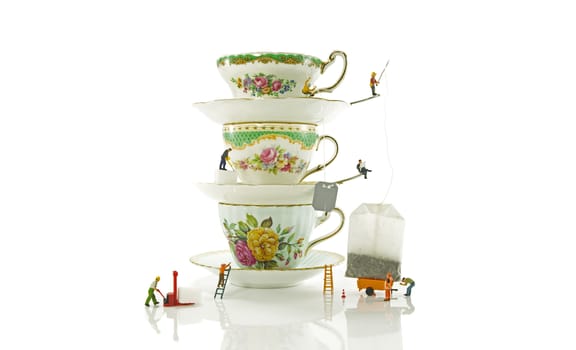 miniature puppets making an English high tea with sugar