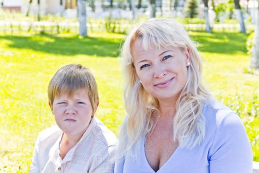 Portrait of European beautiful woman with pose face son in park