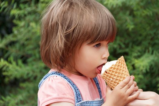 Photo of cute girl are eating icecream in summer