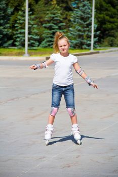 Photo of cute girl on roller skates in summer