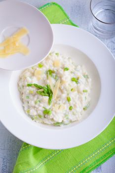 Risotto with Asparagus and cheese served on a table