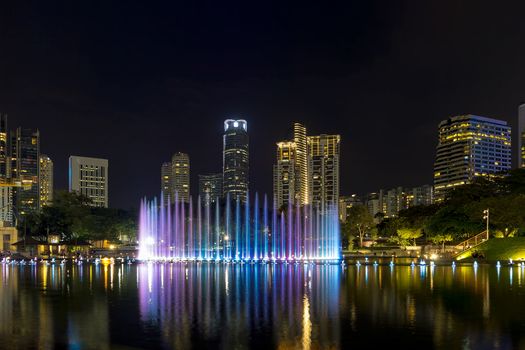 Kuala Lumpur Malaysia City Skyline from KLCC Park by Symphony Lake water fountain light show at night