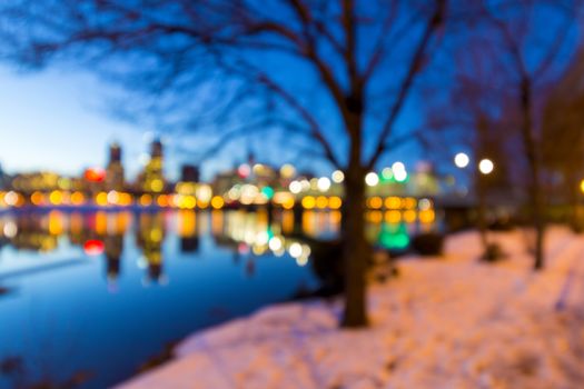 Portland Oregon downtown skyline along Willamette River during winter blue hour blurred defocused bokeh