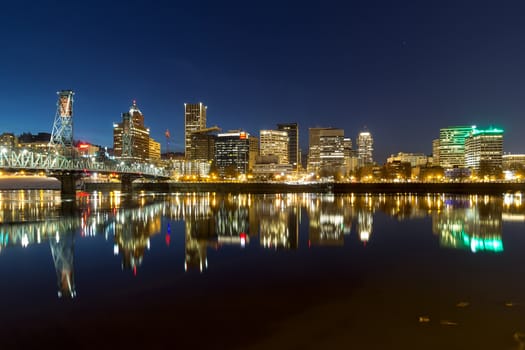 Portland Oregon downtown city skyline reflection on Willamette River during evening blue hour