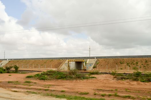 Passage of vehicles under the Mombasa railway line to Nairobi with a height control bar in Kenya