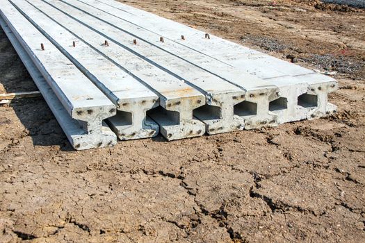 Concrete Stake at construction site with yellow truck in background