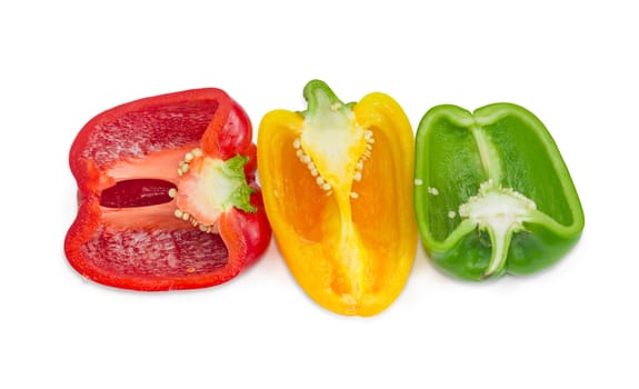 Green, yellow and red fresh bell peppers, cut in half on a light background
