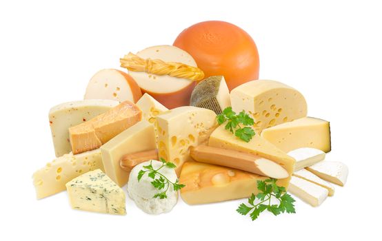 Different pieces of hard cheese, semi-soft cheese and soft cheese various types and twigs of parsley on a light background
