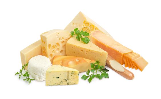 Several different pieces of hard cheese, semi-hard cheese and soft cheese various types and twigs of parsley on a light background
