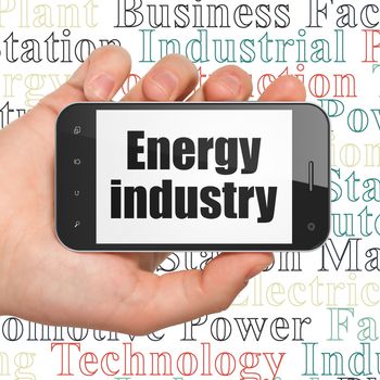 Industry concept: Hand Holding Smartphone with  black text Energy Industry on display,  Tag Cloud background, 3D rendering