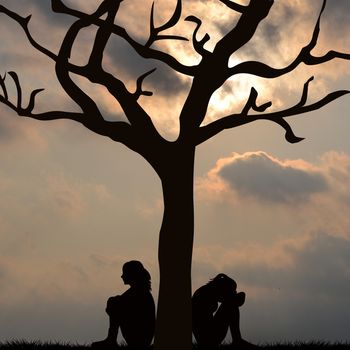 Silhouette of sad women sitting under the tree