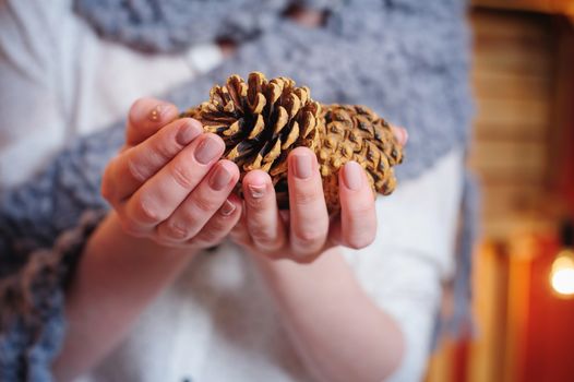 woman holding a pine cones in studio