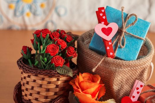 Heart-shaped and gift box with flowers on the basket.