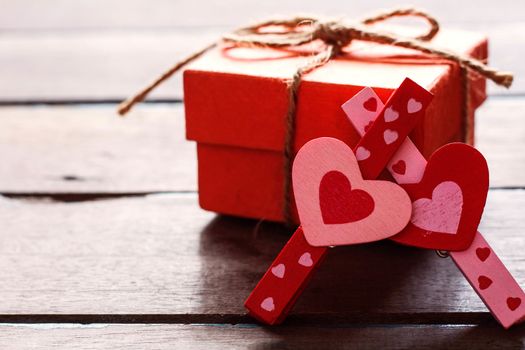 pink and red heart shaped and gift box on a wooden.