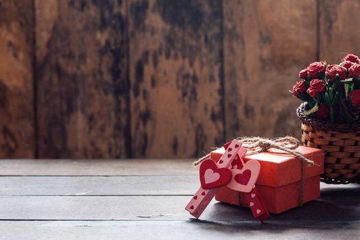 pink and red heart shaped and gift box on a wooden table.