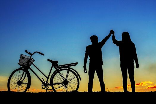 young man and girl holds the hand with the silhouettes.