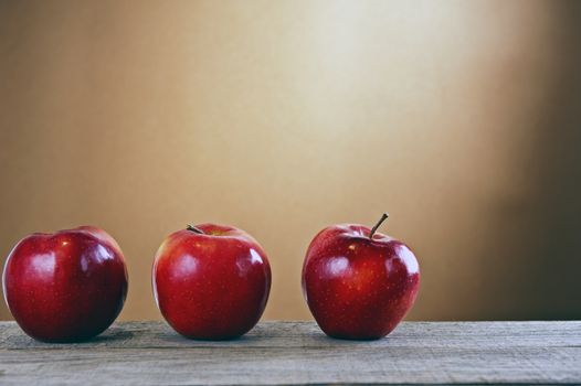 Red apples on a wooden table